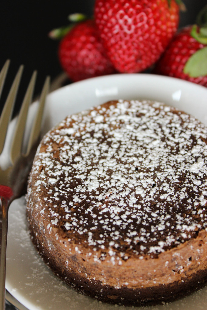 molten chocolate cake with strawberries and powdered sugar