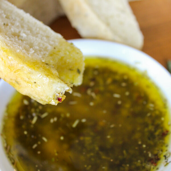 dipping bread into Italian dipping oil