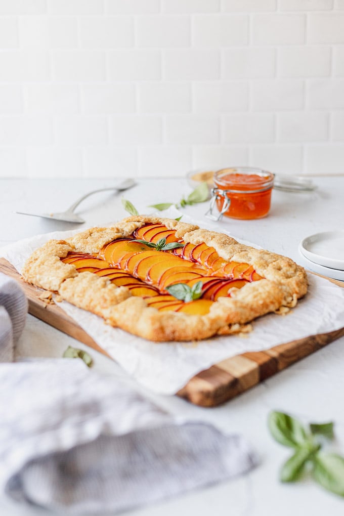 peach galette on cutting board with linen