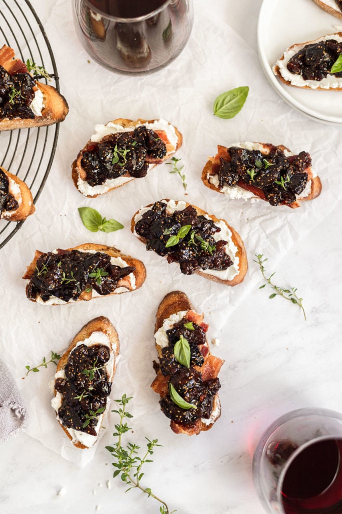 Overhead fig crostini on wire rack and parchment paper.