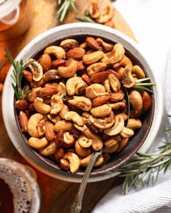 Bowl of sweet and spicy nuts with spoon.