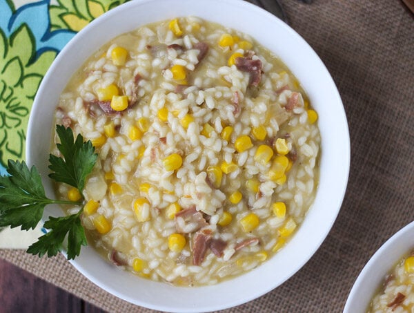 Corn and Prosciutto Risotto is full of creamy decadence, balanced out with salty prosciutto and sweet pieces of corn.