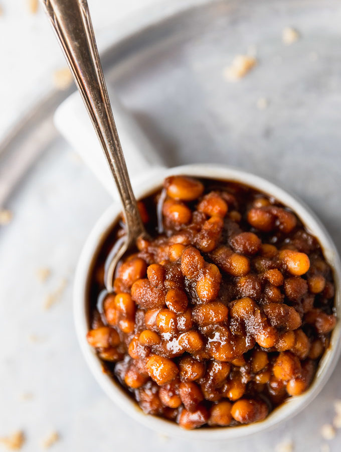 overhead baked beans in small bowl with spoon
