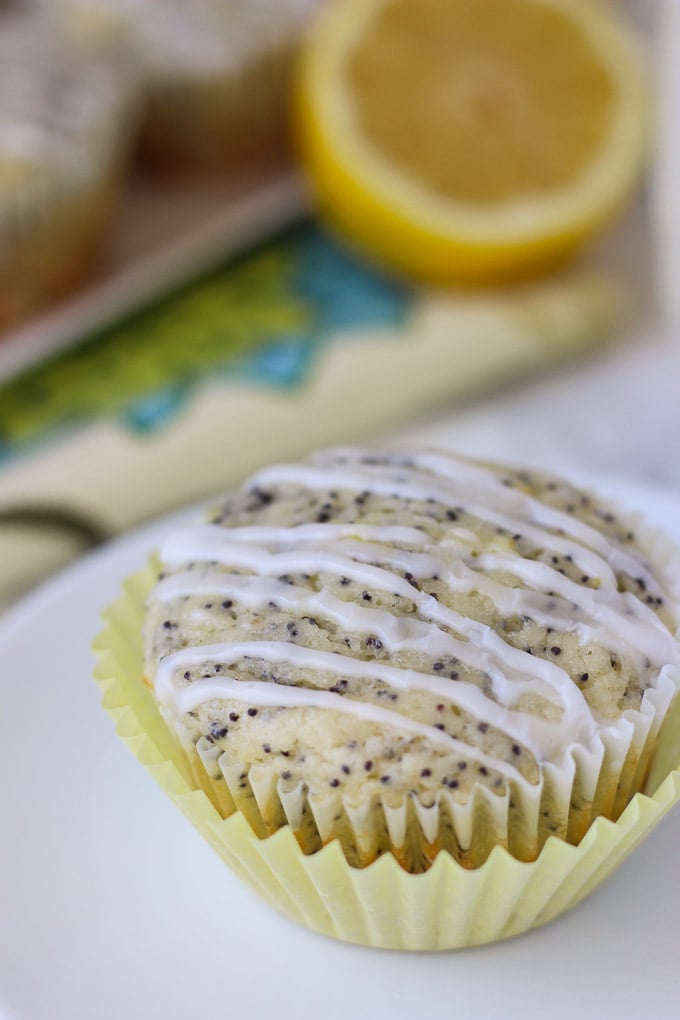 Lemon Poppy Seed Muffins with Almond Icing - moist muffins with light lemon flavor, bursting with poppy seeds, and drizzled with a sweet almond icing! They will brighten up your breakfast!