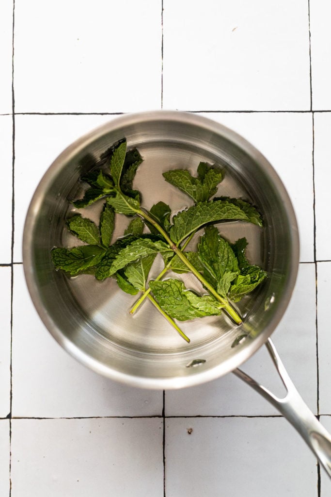 Saucepan with simple syrup and mint.