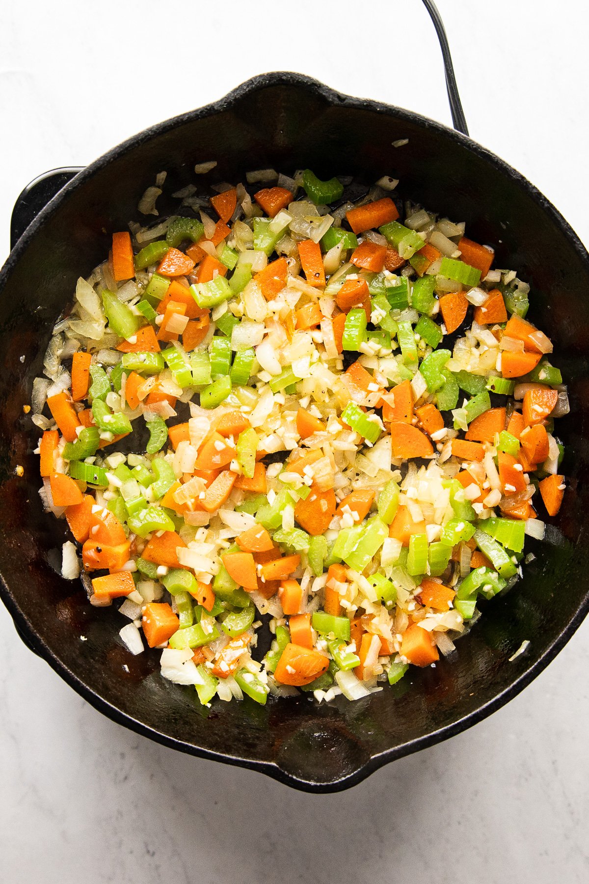 skillet with sauteed carrots, celery, onions, and garlic.