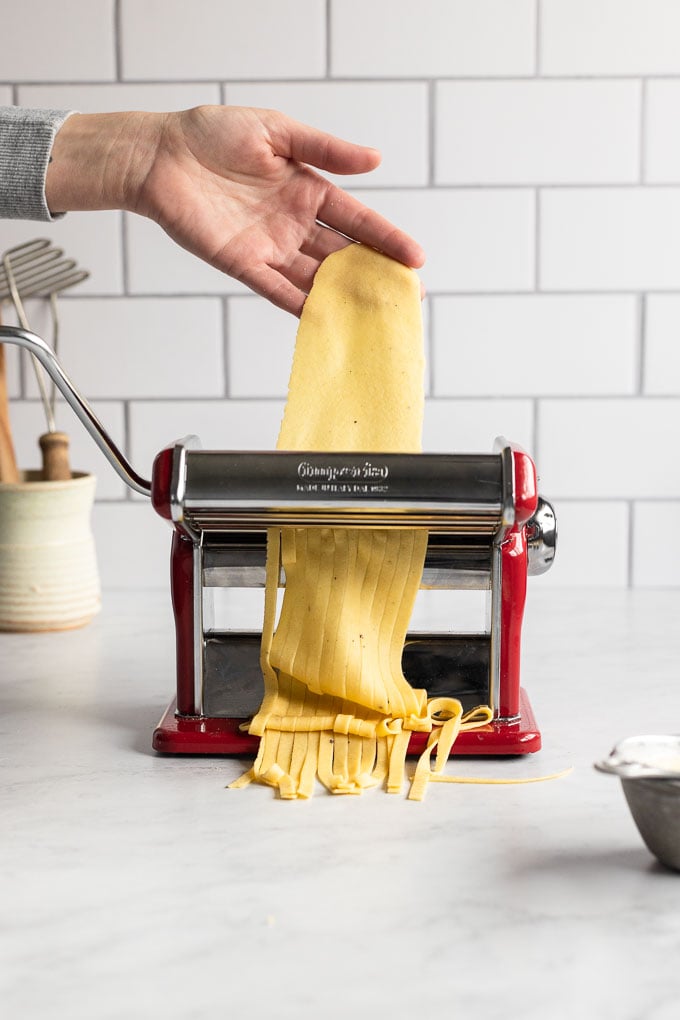 Noodles being cut in pasta machine.