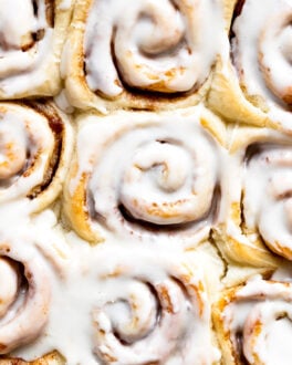 Up close buttermilk cinnamon rolls with icing.