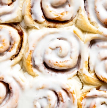 Up close buttermilk cinnamon rolls with icing.