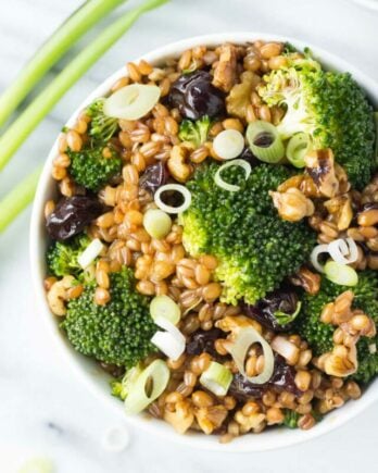 Bowl of wheat berry salad with broccoli florets.