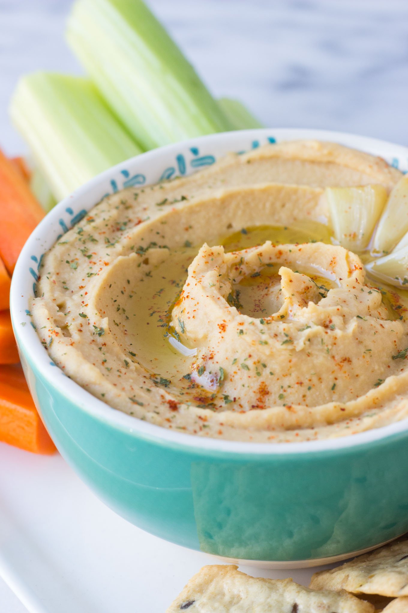Roasted Garlic Hummus - smooth, creamy hummus with the rich, deep flavor of roasted garlic throughout. Perfect to serve as an appetizer, spread on a sandwich, or take for lunch!