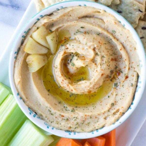 Roasted Garlic Hummus - smooth, creamy hummus with the rich, deep flavor of roasted garlic throughout. Perfect to serve as an appetizer, spread on a sandwich, or take for lunch!