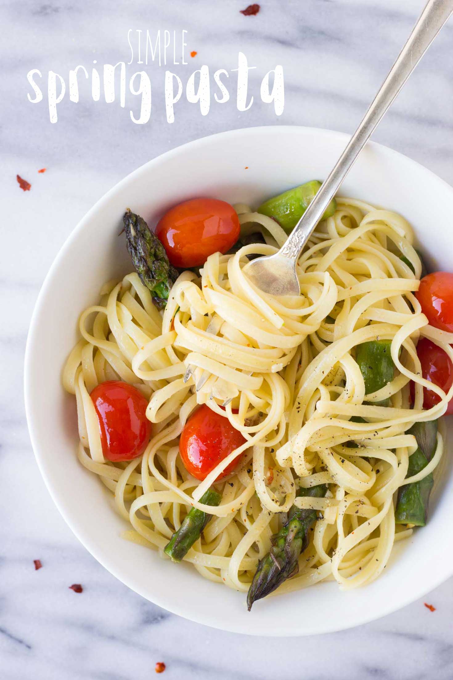 Simple Spring Pasta - fettuccine tossed in a light garlic sauce with fresh asparagus and juicy tomatoes. | Fork in the Kitchen