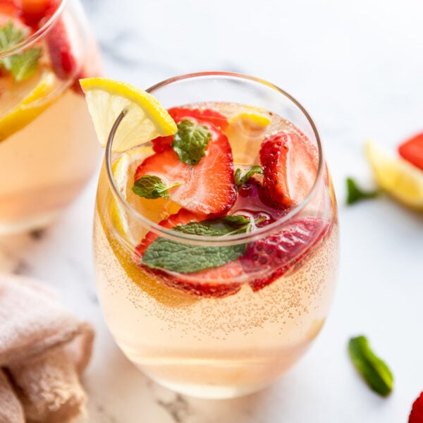 Glasses of rose sangria with strawberries and mint.