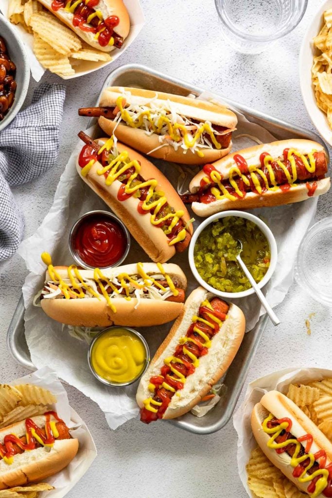 Tray of vegetarian hot dogs with toppings.