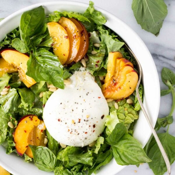 Nectarine Burrata Basil Salad - A cheese-board inspired salad with sweet nectarines, creamy burrata, fresh basil, and crunchy pine nuts tossed with a tangy, peppery dressing. | Fork in the Kitchen