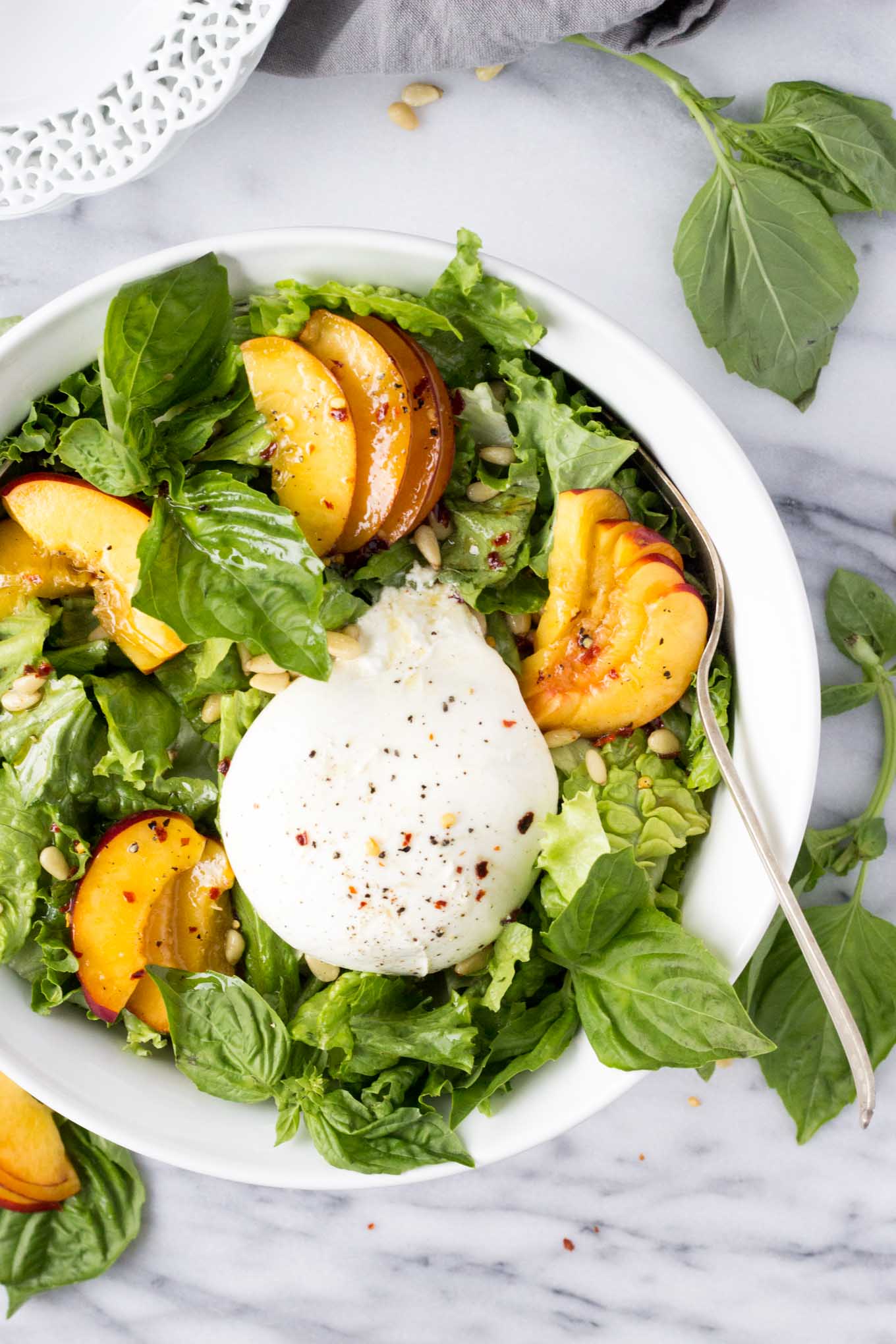Nectarine Burrata Basil Salad - A cheese-board inspired salad with sweet nectarines, creamy burrata, fresh basil, and crunchy pine nuts tossed with a tangy, peppery dressing. | Fork in the Kitchen