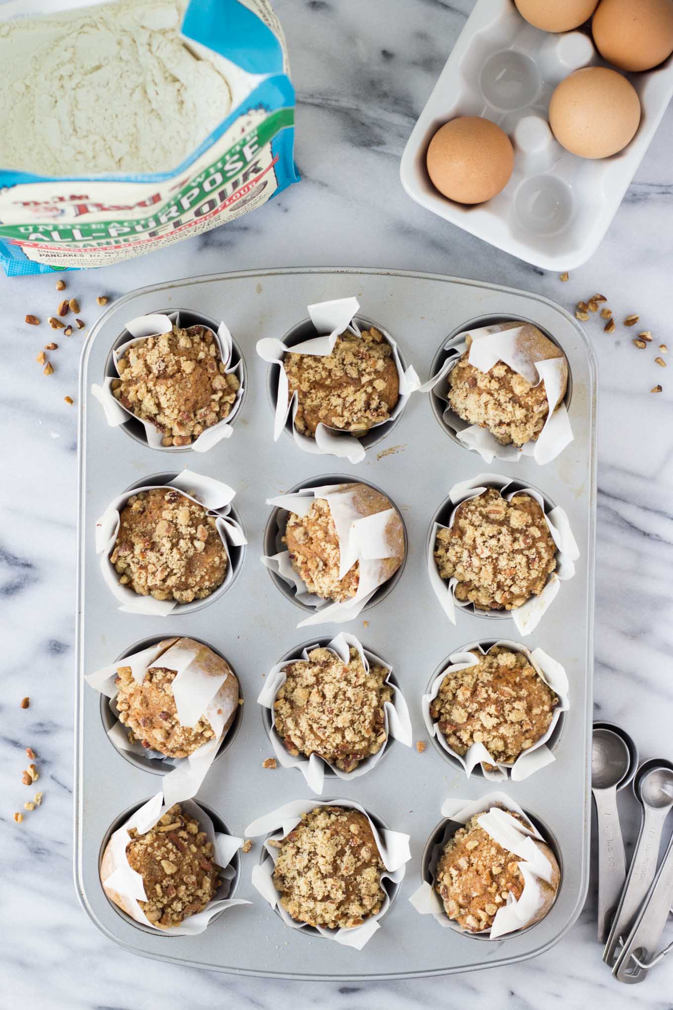 Baked muffins with crumble in muffin tin.