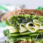 Green vegetable sandwich on tray.