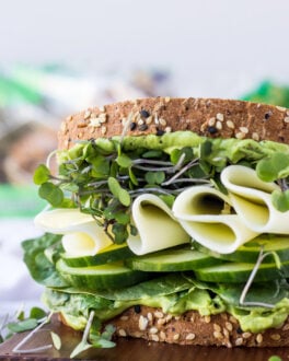 Green vegetable sandwich on tray.