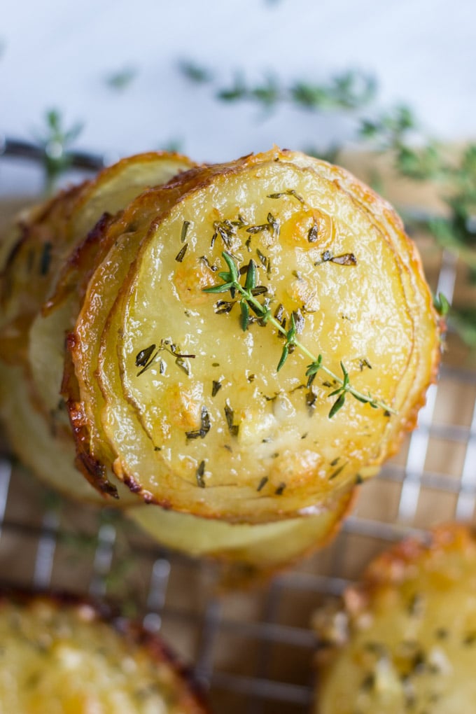 Overhead stack of potatoes with thyme sprig.