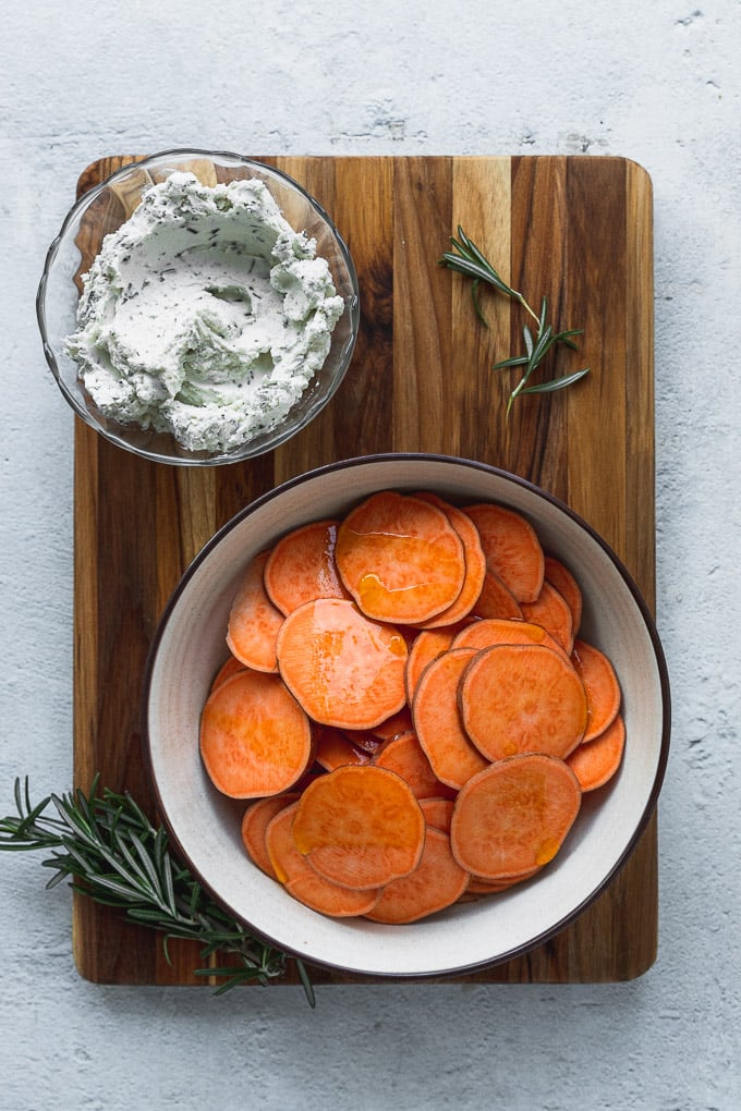 Bowl of goat cheese mixture and bowl of sweet potato rounds.
