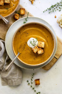 Bowl of squash soup with spoon.