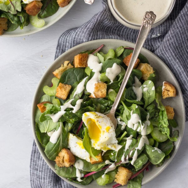 Simple Dijon Salad - a tangy dressing drizzled over a bed of lettuce with a perfectly poached egg and crunchy croutons! Simple, delicious dinner! | Fork in the Kitchen