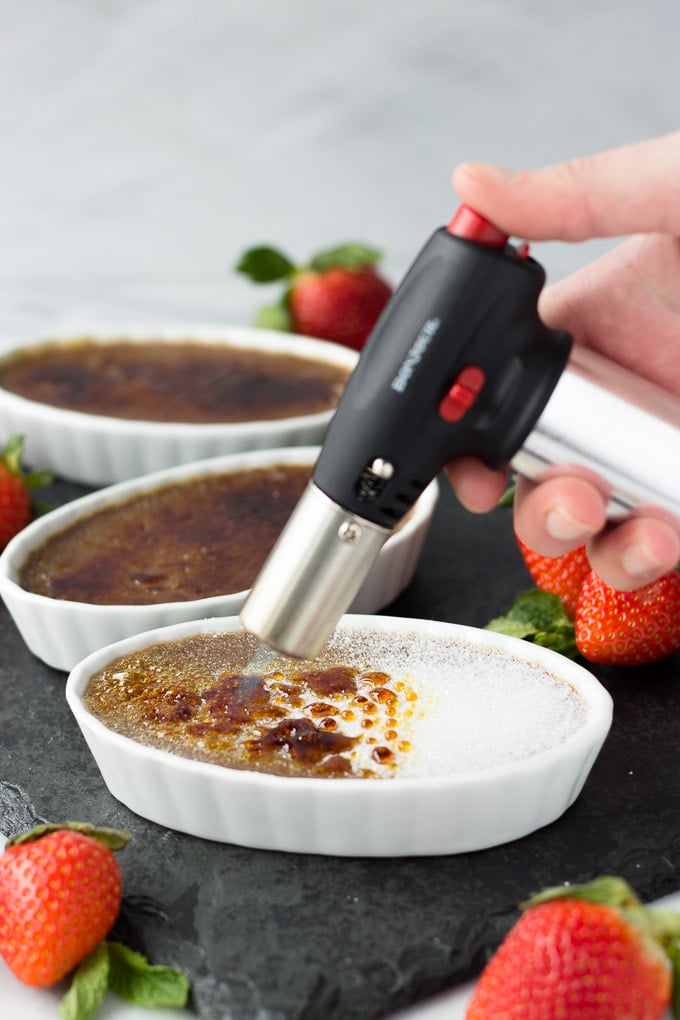 Nutella Creme Brûlée - A dessert dressed to impress! A subtle tone of Nutella in a creamy custard base with a brûléed sugar top layer. Garnish with strawberries for a delectable dessert! | Fork in the Kitchen