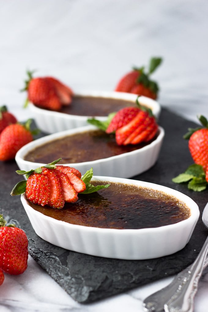 Nutella Creme Brûlée - A dessert dressed to impress! A subtle tone of Nutella in a creamy custard base with a brûléed sugar top layer. Garnish with strawberries for a delectable dessert! | Fork in the Kitchen