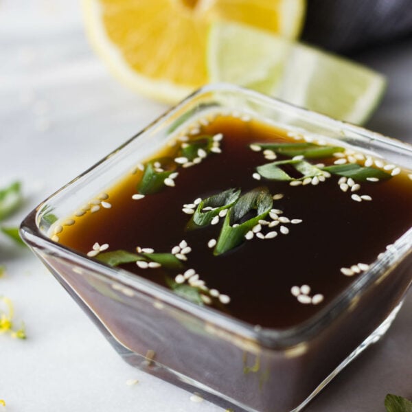 Ponzu sauce in small bowl with green onion.
