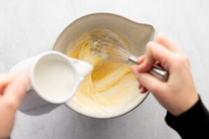Whisking eggs with cream.