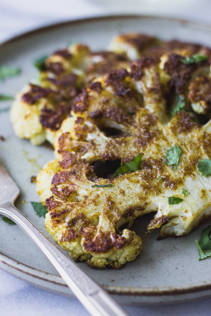 Roasted Cauliflower Steaks - a flavorful spice mix over creamy roasted cauliflower. A simple vegetarian dinner! | Fork in the Kitchen