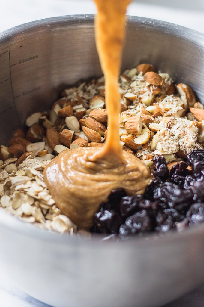 almond butter mixture pouring into ingredient bowl