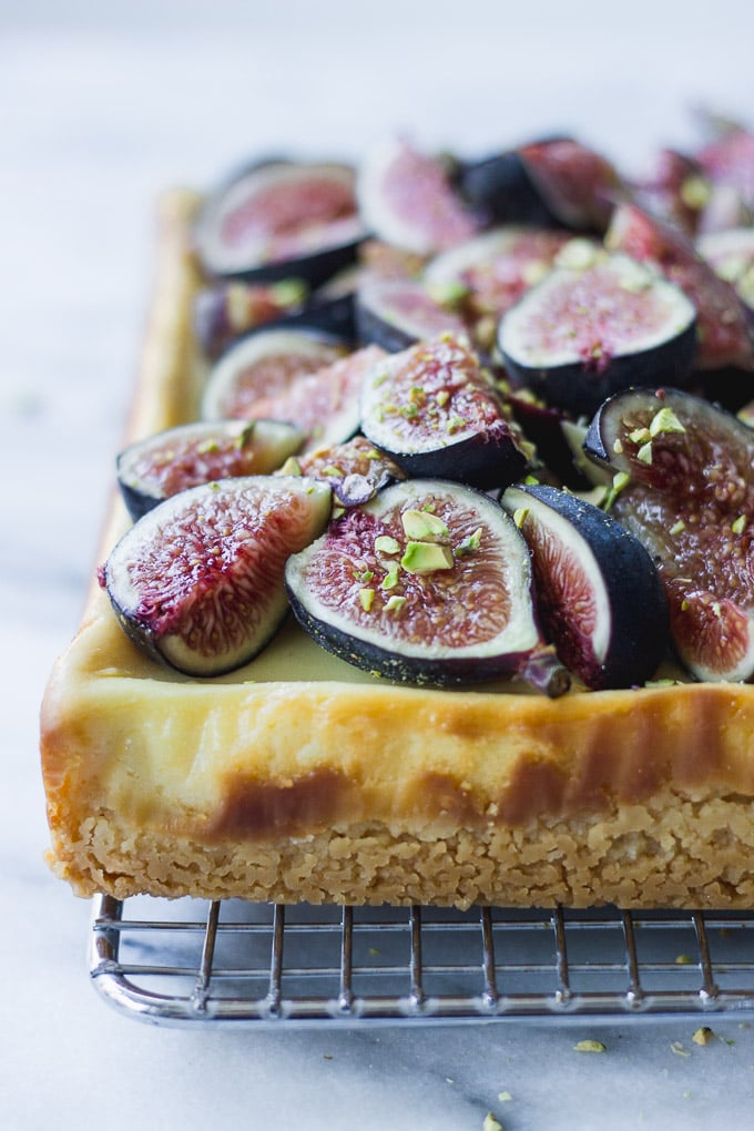 side shot of honey cheesecake bars with figs and pistachios