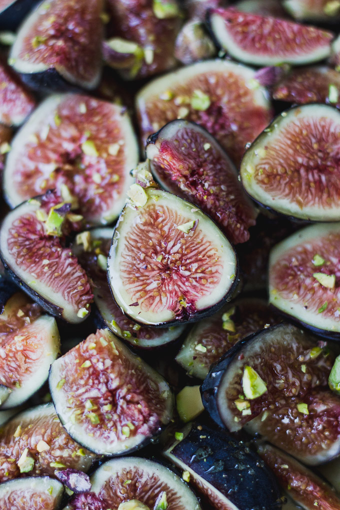 close up of figs with pistachios and honey