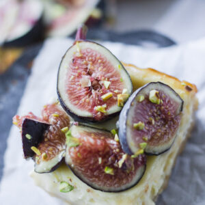 close up honey cheesecake bar with figs and pistachios