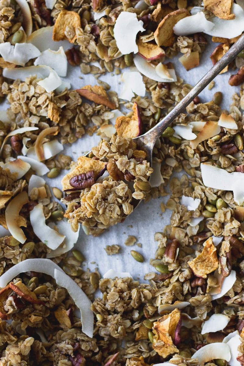 easy autumn spice granola overhead on baking sheet by fork in the kitchen