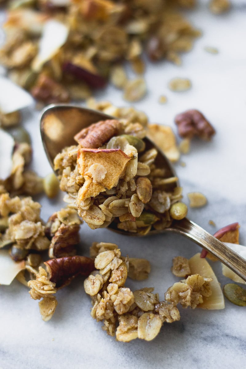 easy autumn spice granola on spoon by fork in the kitchen