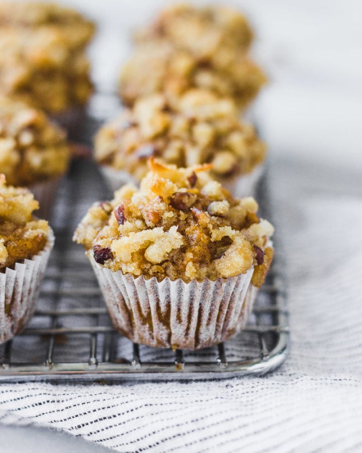 mini pumpkin coconut muffins on cooling rack with linen by fork in the kitchen