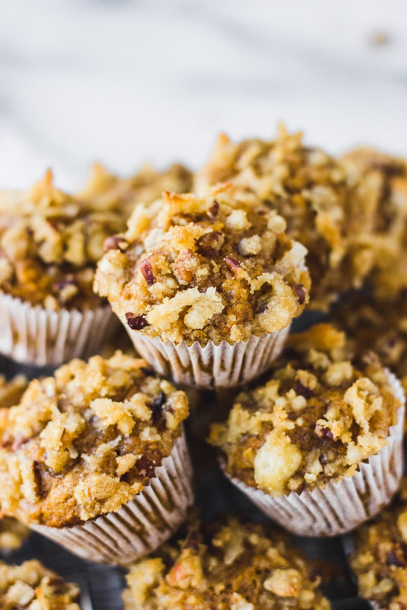 mini pumpkin coconut muffins in a pile by fork in the kitchen