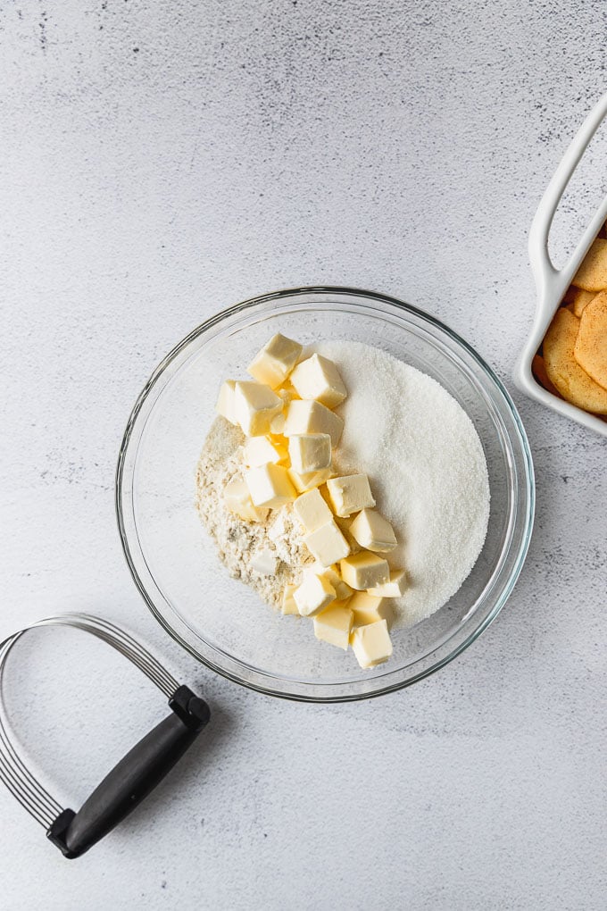 Cubed butter, flour, and sugar in bowl.