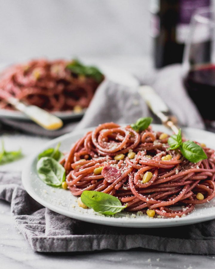 red wine spaghetti on plate with fork by fork in the kitchen