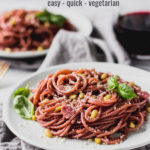 red wine spaghetti on plate with fork by fork in the kitchen