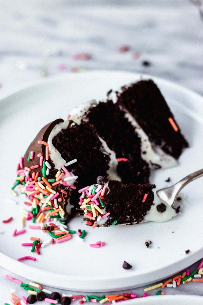 Mini Chocolate Cake with Sour Cream Frosting on plate with fork and bite | Fork in the Kitchen