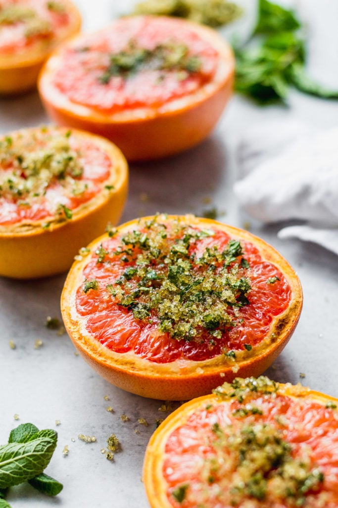 broiled grapefruit with mint and sugar by fork in the kitchen