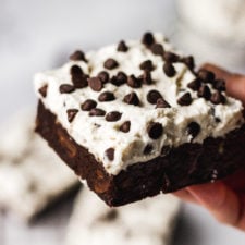 hand holding up cannoli brownie by fork in the kitchen
