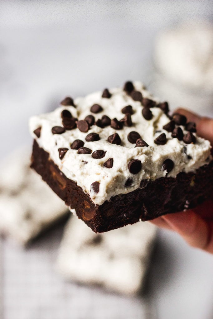 hand holding up cannoli brownie by fork in the kitchen