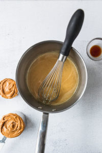 saucepan with melted sugar and honey with whisk.