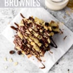 brownies with salted caramel, potato chips, and a chocolate drizzle by fork in the kitchen